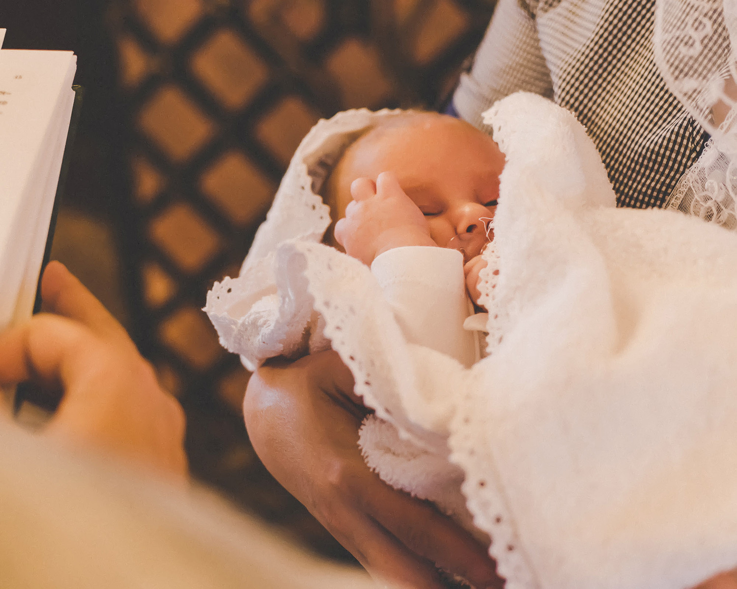 The sacrament of the baptism of a child. Selective focus. People.